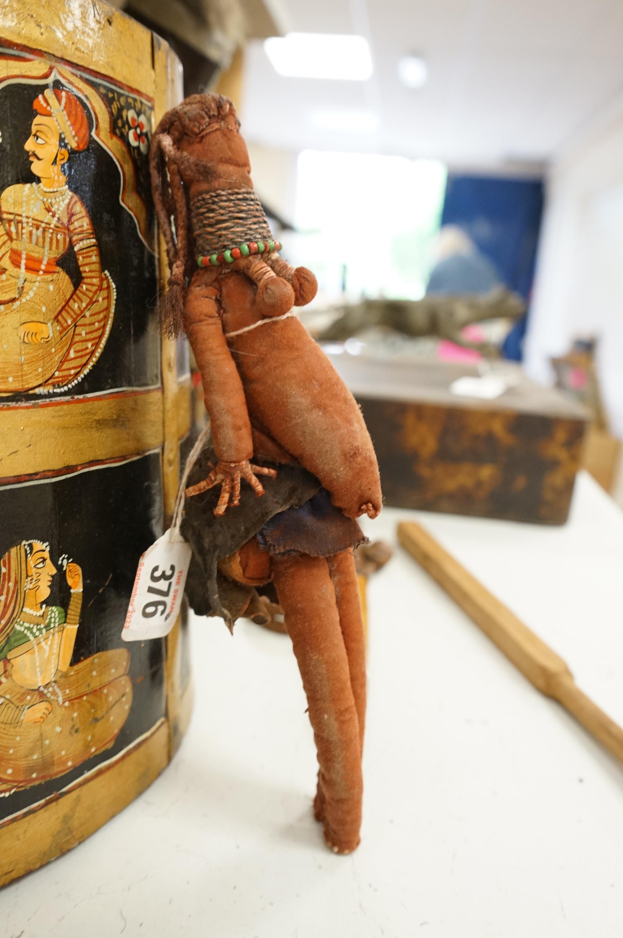 A collection of tribal and Asian collectables including a Tibetan prayer wheel, carvings, etc.